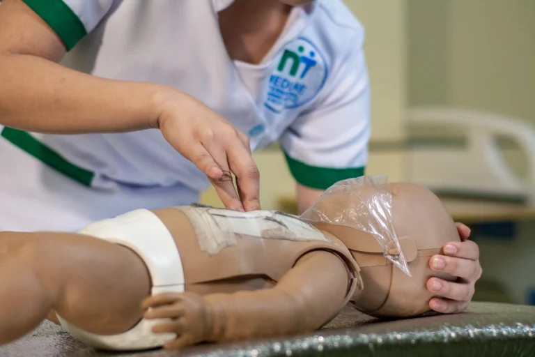 A student cares for an infant training manikin