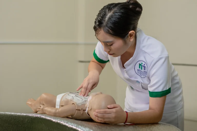 A student bathes an infant manikin