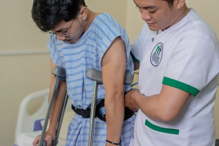 A student adjusts a patient’s gait belt