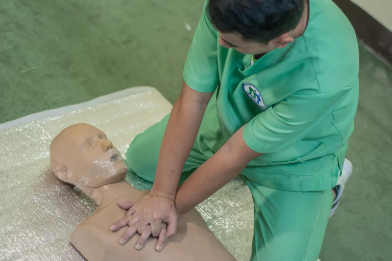 Close-up of a student practicing chest compressions